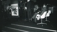 Object Speakers at a modern art exhibition seated on a stagehas no cover picture