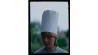 Object Woman wearing a chef's hathas no cover