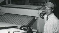 Object Worker standing beside machinerycover