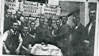 Object Male workers from Jacob's Biscuit Factory gathered beside crates of biscuitscover picture