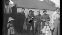Object Photograph of Blasket Islanders in front of a cottagecover picture