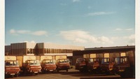 Object Boland's Biscuits delivery trucks outside a factorycover