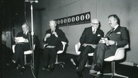 Object Gordon Lambert seated on the stage at an art exhibitioncover picture