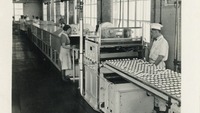 Object Workers operating the chocolate coating machine at Aintreecover picture